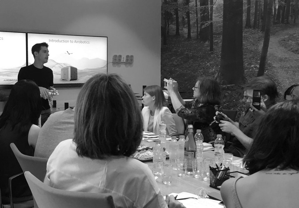 a man speaking about airobotics at a meeting