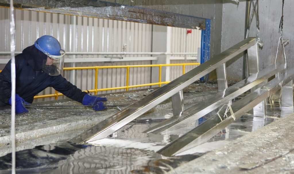 A man welding handrail of steel stair