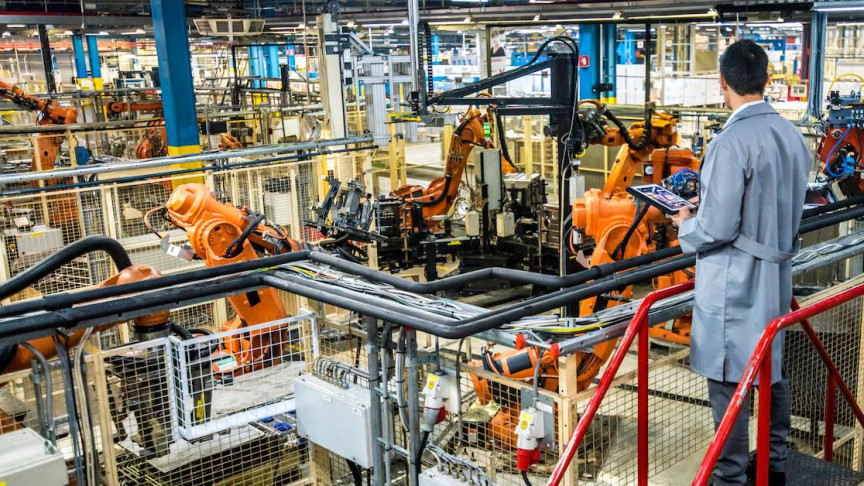 Industrial engineer working on a place full of machines
