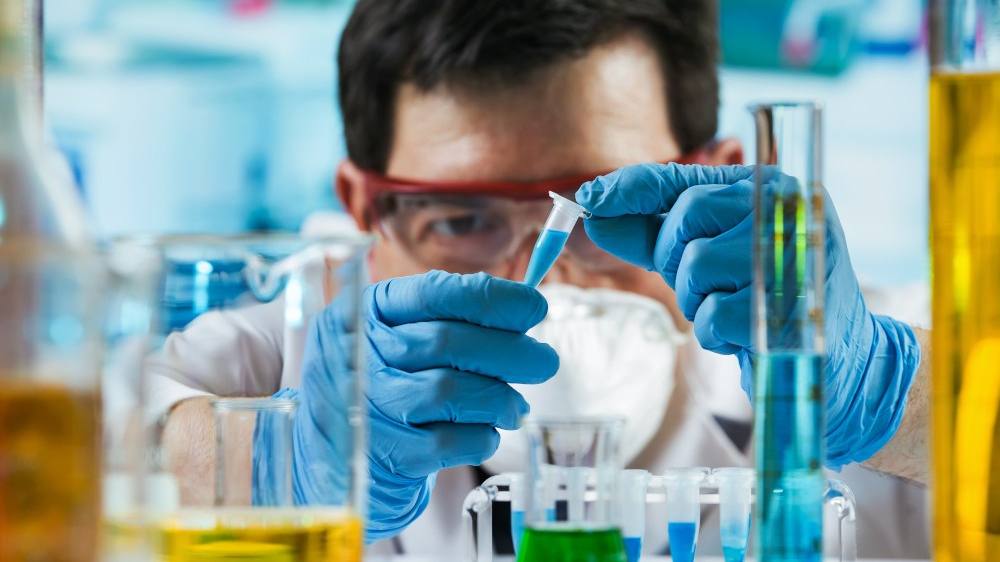 A chemist working in laboratories and testing some product